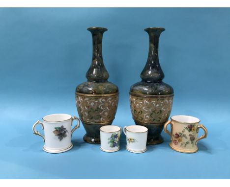 Pair of Royal Doulton stoneware vases and four Royal Worcester miniature cups