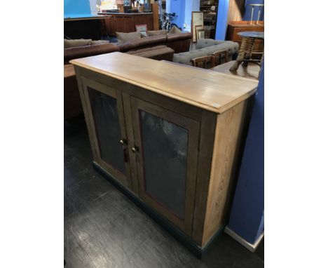 A light oak two door cabinet