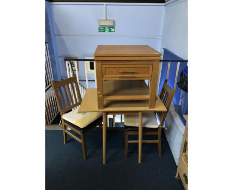 A kitchen table, two chairs and a light oak unit
