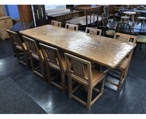 A 1970's Sid Pollard Robert Mouseman Thompson design table and a set of eight Robert Mouseman Thompson design lattice back si