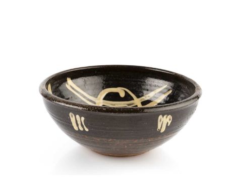 Ray Finch (1914-2012) at Winchcombe PotteryAn early slipware bowlimpressed potter's and pottery seal11cm high, 25.5cm diamete