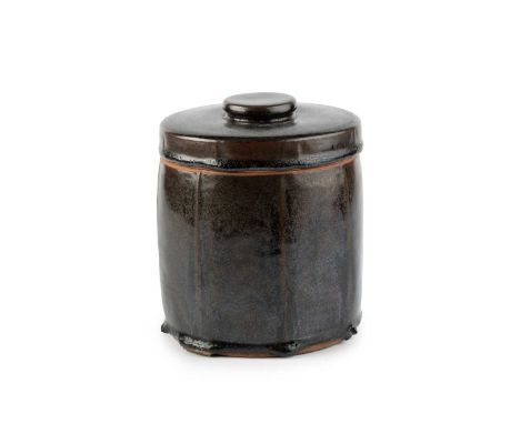 Norah Braden (1901-2001)Pot and coverstoneware, with cut sides and tenmoku glazeimpressed potter's seal18cm high.Free from cr