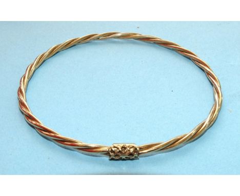 A 9ct gold bangle of twist design, 64mm diameter, 5.3g. 