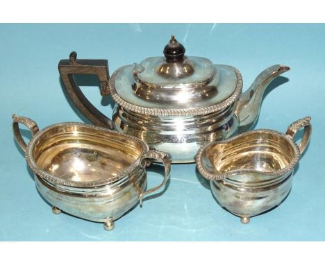 A George V silver three-piece tea service with gadrooned rim by Goldsmiths and Silversmiths Co, London 1913, inscription and 