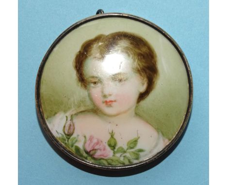 A Victorian silver-mounted brooch with hand-painted portrait of a young girl with roses, on porcelain, 6cm diameter. 