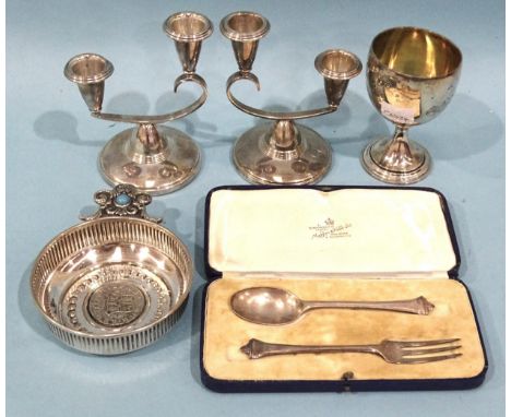 A pair of silver small two-branch candlesticks of asymmetrical form on circular ribbed bases, (loaded), Birmingham 1962, 12.5