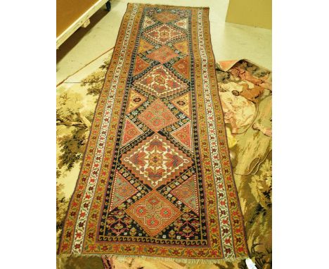 A Persian tribal runner with seven medallions within polychrome borders, 98cm x 258cm and a machine tapestry after a design b