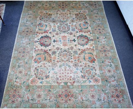 A modern Egyptian carpet, the ivory field with an allover bold palmette and flower design, beige flower head border, 397cm x 