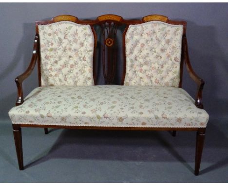 An Edwardian mahogany and marquetry inlaid two seater sofa with button back upholstery on tapering supports, 125cm wide. 