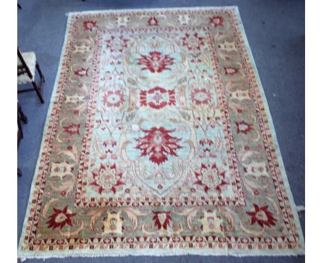 A Heriz carpet, Persian, the pale indigo field with bold madder palmettes and vine design, a complementary palmette and leaf 