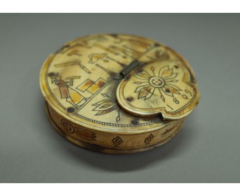 An unusual animal horn circular snuff box dated 1809, coloured and engraved with a couple building a house, 8cm diameter. 