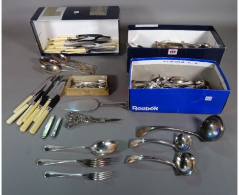 A quantity of plated table flatware, including knives, forks and spoons, a soup ladle, condiment spoons, two pocket knives, a