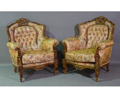 A set of four 20th century hardwood framed armchairs with button back gold floral upholstery, on scroll supports, (4). 