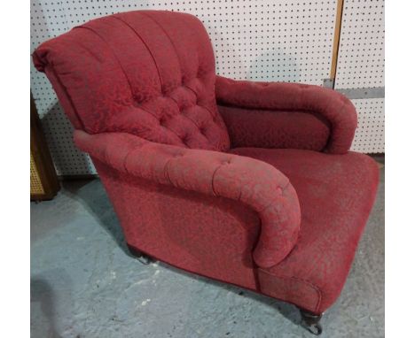 A mid-Victorian easy armchair with button back and overstuffed arms on turned supports, 78cm wide x 84cm high.
