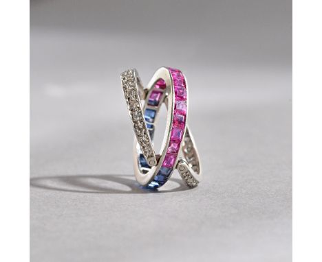 A diamond, ruby and sapphire set swingover and under eternity ring, the principal band mounted with a row of calibre cut rubi