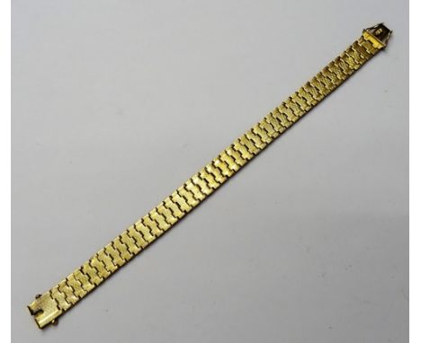 A gold bracelet, the shaped links with engine turned decoration, on a snap clasp, detailed indistinctly 9 C, weight 13.5 gms.