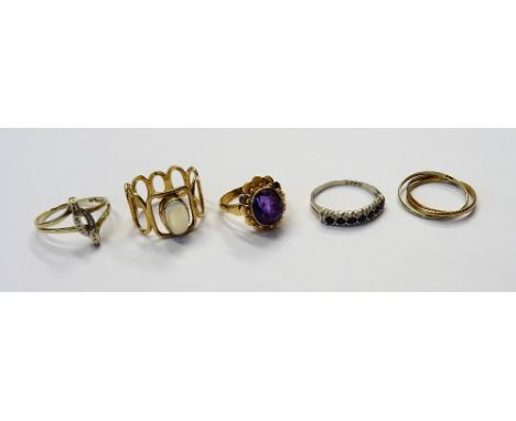 A 9ct gold ring, mounted with an oval moonstone, the mount in a pierced oval openwork design, a gold ring, mounted with an ov