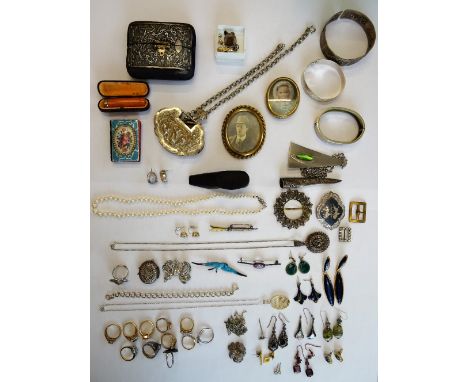 An oval photographic portrait miniature of a lady, displayed in a filigree fronted case, three bangles, five brooches and pin