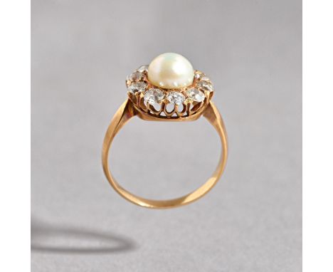 A gold, diamond and cultured pearl cluster ring, mounted with a single cultured pearl in a surround of ten cushion shaped dia