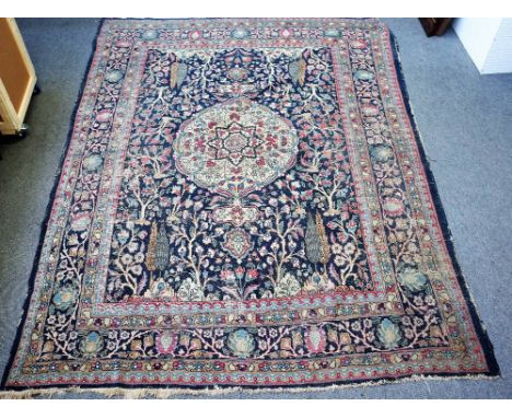 A Persian blue ground carpet, possibly Tabriz, central medallion with Cypress tree surround, approximately 379cm x 275cm (wor