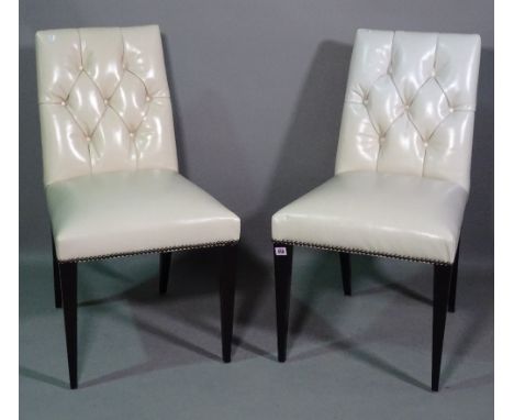 Baker; a set of seven 20th century dining chairs with white leather button back upholstery, (7). 