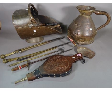A wrought iron fire guard, a wrought iron fender, various fire tools, a copper jug and a coal scuttle. 