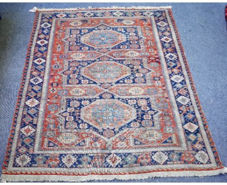 An antique Soumac carpet, possibly South Caucasian, the madder field with three bold medallions supporting motifs; an indigo 