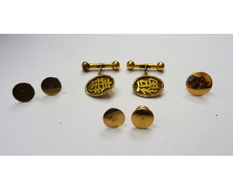 A pair of Asian gold cufflinks, the oval fronts with character motifs, detailed S.F 18, with associated gilt dumb bell fittin