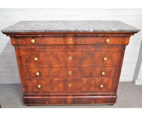 An early 19th century French commode, the marble top over a figured walnut base of five long graduated drawers, 130cm wide x 