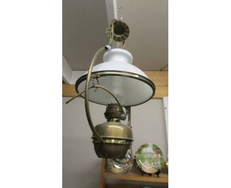 A Victorian brass hanging oil lamp with shade (converted to electric).