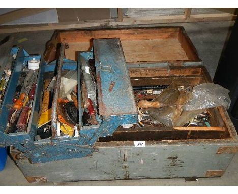 A large wooden box and a tool box full of tools.
