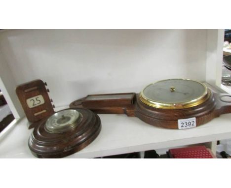 A mid 20th century Smith's barometer, another barometer and a perpetual calendar.
