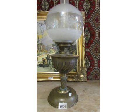 A Hinks brass oil lamp with original burner and later etched glass shade.