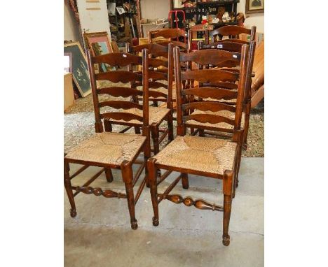 A set of 6 oak ladder back chairs.