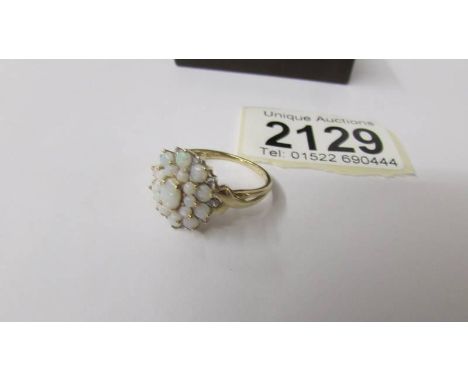 A 9ct gold opal cluster ring, size R, 2.8 grams total weight.