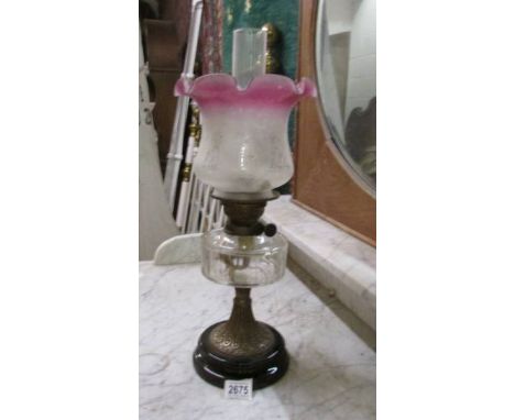 A Victorian oil lamp with later shade.