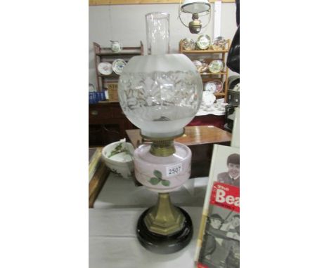 An early 20th century oil lamp with hand painted font and acid etched shade.