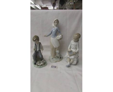 Three NAO figurines - Girl with dog, boy with dog and girl writing on a slate.