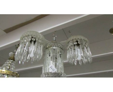 An unusual contemporary three lamp glass chandelier.