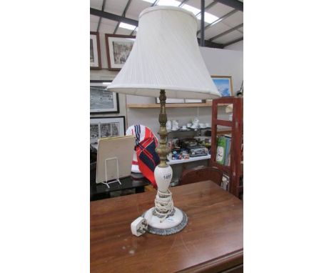 A vintage onyx and gilded white metal table lamp with shade, overall height 67 cm, lamp 51 cm.