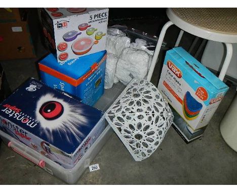 A large box with hand held vacuum cleaner, assorted cleaning items, space saving vacuum bags, Vax cleaning pads, metal lamp s