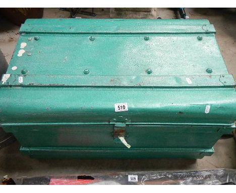 A large tin box full of tools.