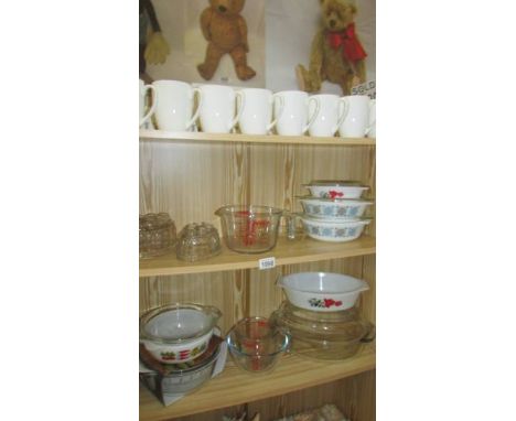 A good lot of Pyrex, jelly moulds, set of Royal Worcester mugs etc.,