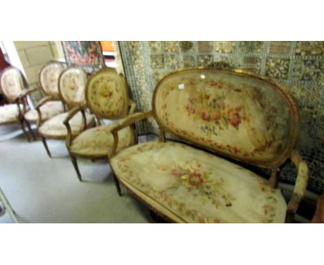 An early 19th century gilt and tapestry suite comprising 2 seat sofa and 4 arm chairs ****Condition report**** Gilding is fad