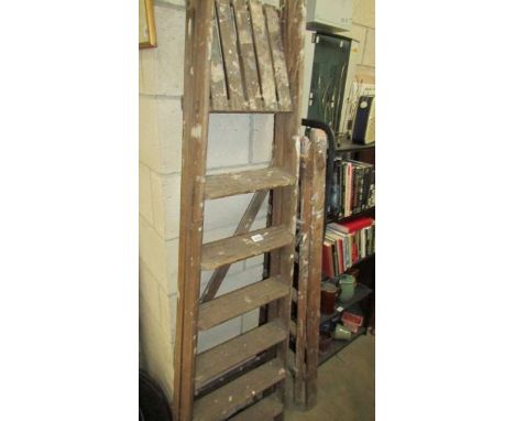 Two vintage wooden step ladders.