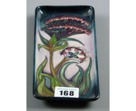 A MOORCROFT PEN TRAY, a 20 cms long pen tray with stylized floral and leaf pattern on a tonal blue pink ground, initialled 'W