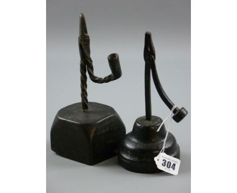 TWO ANTIQUE AND LATER RUSH LIGHT HOLDERS, an 18th Century possibly West Country example driven into a circular conical shaped