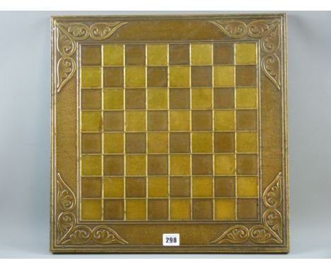 A CHESS BOARD IN THE ARTS & CRAFTS STYLE a copper and brass chess board decorated with floral scrolled corners, 46 cms square