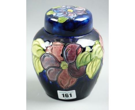 A MOORCROFT CLEMATIS GINGER JAR, a 15 cms high ginger jar and cover decorated on a cobalt blue ground, green Moorcroft signat