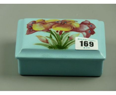 A MOORCROFT FREESIA TRINKET BOX, a rectangular trinket box and cover decorated on an unusual light blue ground, Moorcroft sig
